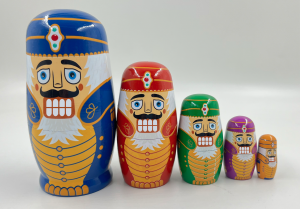 Hand-painted Nutcracker nesting dolls, festive snow globes, themed scarves, and silk or polyester neckties available in Ballet West’s 2025 collection.