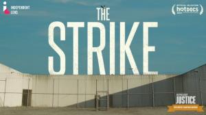 Photo of an empty prison yard with the text, THE STRIKE written across a sunny blue sky.