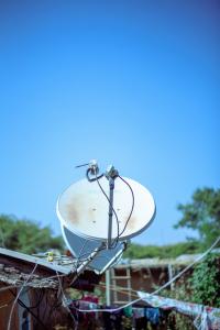 Singular satellite dish on a rooftop