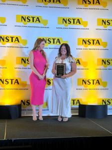 Michelle with Award on Stage