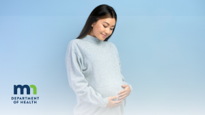 Pregnant woman in a soft gray sweater gently cradling her belly, smiling, against a soothing blue background. Logo reads "MN Department of Health."