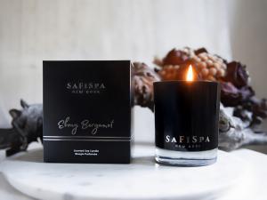 Luxury aromatherapy candle with citrus and spice scent in black jar