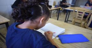 A child evacuated from Gaza studies at school in Bethlehem