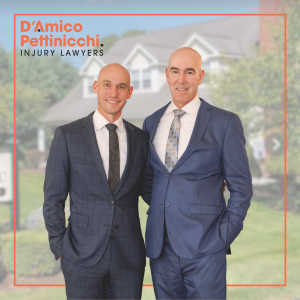 Jeremy D’Amico and Michael A. D’Amico, attorneys at D’Amico Pettinicchi, Injury Lawyers, standing side by side in professional attire in front of their Watertown, Connecticut office.