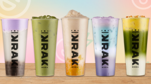 Five colorful Krak Boba drinks lined up on a wooden surface with a pastel gradient background.