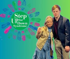 Connor Long and Megan Bomgaars standing with the Step Up for Down Syndrome Walk shoeprint logo