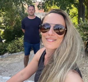 Ana Mitrovic and her husband Goran smiling together outdoors. Their partnership reflects the freedom and balance Ana created through her successful work-from-home business.