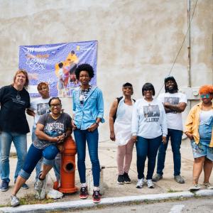 Standing in front of the future mural site at 2600 Ridge Ave, outside Kirby Mack Barbershop in North Philly.