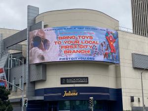 Christmas in July billboard on building.
