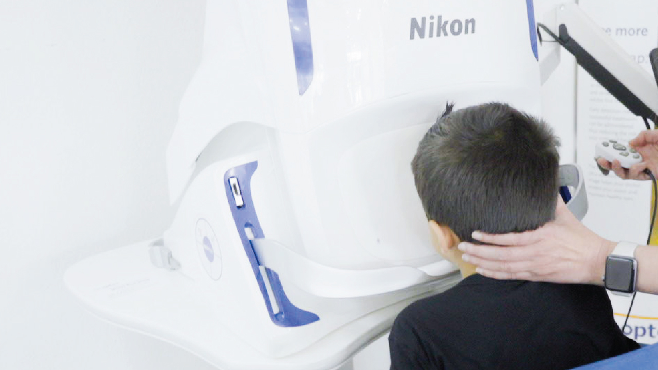 A child getting an eye exam for back-to-school at TSO Champion, a Houston eye doctor prioritizing academic success.