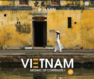 Cover of Vietnam, Mosaic of Contrasts II featuring the photograph “Tradition” by Réhahn, showing a Vietnamese woman in white áo dài walking past a yellow heritage wall in Hoi An.