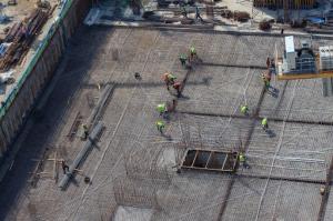 Aerial view of workers installing concrete at an active construction site