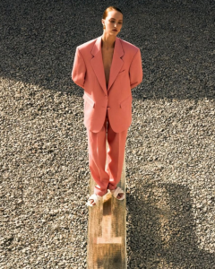 Woman in oversized peach colored suit
