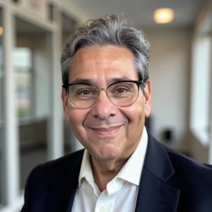 "José Pereira, bestselling author and resilience coach, standing confidently beside the official announcement graphic of his new partnership with Bruce Merrin’s Celebrity Speakers Bureau, symbolizing a powerful step forward in his global mission to inspir