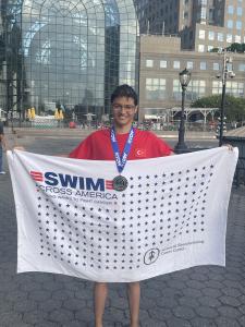 16-year-old swimmer Nevzat Arda Agir smiling after finishing the 28.5-mile 20 Bridges Swim around Manhattan in support of open water awareness and youth athletic achievement.