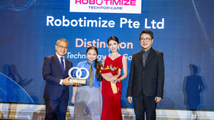 Kerry Guo, CEO and Founder of Robotimize Group, receiving the “Technology for Good” award from Minister Edwin Tong SC, with Garry Lam, Chairman of Brands For Good, standing to the right.