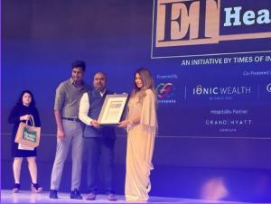 Dr. Mohana Rao Patibandla being awarded at ET Health Conclave 2025 on stage with Mahima Chaudhry, recognizing his excellence in minimally invasive and endovascular neurosurgery.