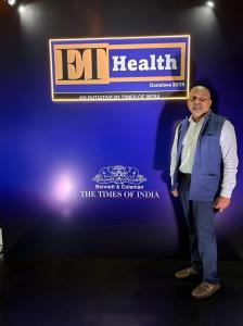 Dr. Mohana Rao Patibandla standing in front of the ET Health Conclave 2025 banner by The Times of India, recognizing top leaders in healthcare across India.
