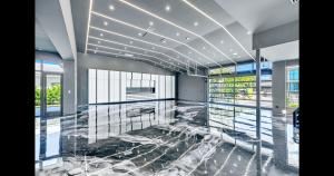 Luxury 3,500 sq ft museum-style garage with polished epoxy flooring, high ceilings, large TVs, climate control, and security, showcasing exotic supercars or collectibles.