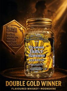 A jar of Elvis Presley Collector’s Edition Peanut Butter Banana Moonshine from South Mountain Distilling Co., displayed against a golden spotlight background. The label features Elvis's image and the text. A gold medal from The Spirits Business Global Ame