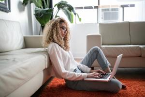 Client attending a virtual therapy session on a laptop from home, with a calming, confidential background