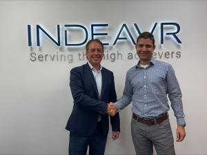 Tom Collins, CEO of Marlabs, and Strahinov, Managing Partner of Data Strategy Services of INDEAVR, shake hands in front of the INDEAVR logo