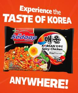 Mi Sedaap Korean Spicy Chicken Fried Ramen in black packaging with egg, chili, and garnishes, over an orange background with the slogan “Experience the Taste of Korea Anywhere.”