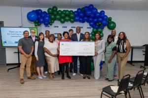 Pictured: Nicor Illinois Community Investment staf f, center , present a check to OAI, Inc while program directors look on. Copyright NICI.