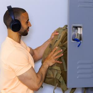 Fitness enthusiast securing gym locker with BenjiLock Outdoor Fingerprint Padlock featuring privacy-first biometric keyless security.