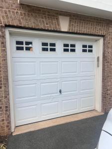 Double garage door with decorative windows installed by Neighborhood Garage Door of Rockville in Potomac, MD.