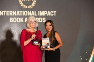 Kathy Sechrist receiving her award from Nim Stant, Founder of Internatioal Impact Award