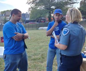 YHR DC Volunteers talking with police about human right education at National Night Out