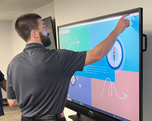 Educators interacting with Promethean ActivPanel 10 features during GO Technology Group classroom technology workshop