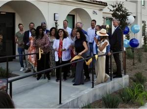 Oceanside Mayor Esther Sanchez cuts the ceremonial ribbon in front of South River Village, a four-story, 43-unit affordable housing community featuring one-, two-, and three-bedroom apartments with modern finishes and family-friendly amenities.