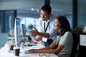 A business man and woman discussing Managed IT Service options for their business.