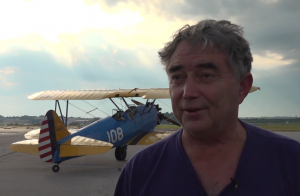 Rick Mantei speaking in front of his PT17 Stearman plane