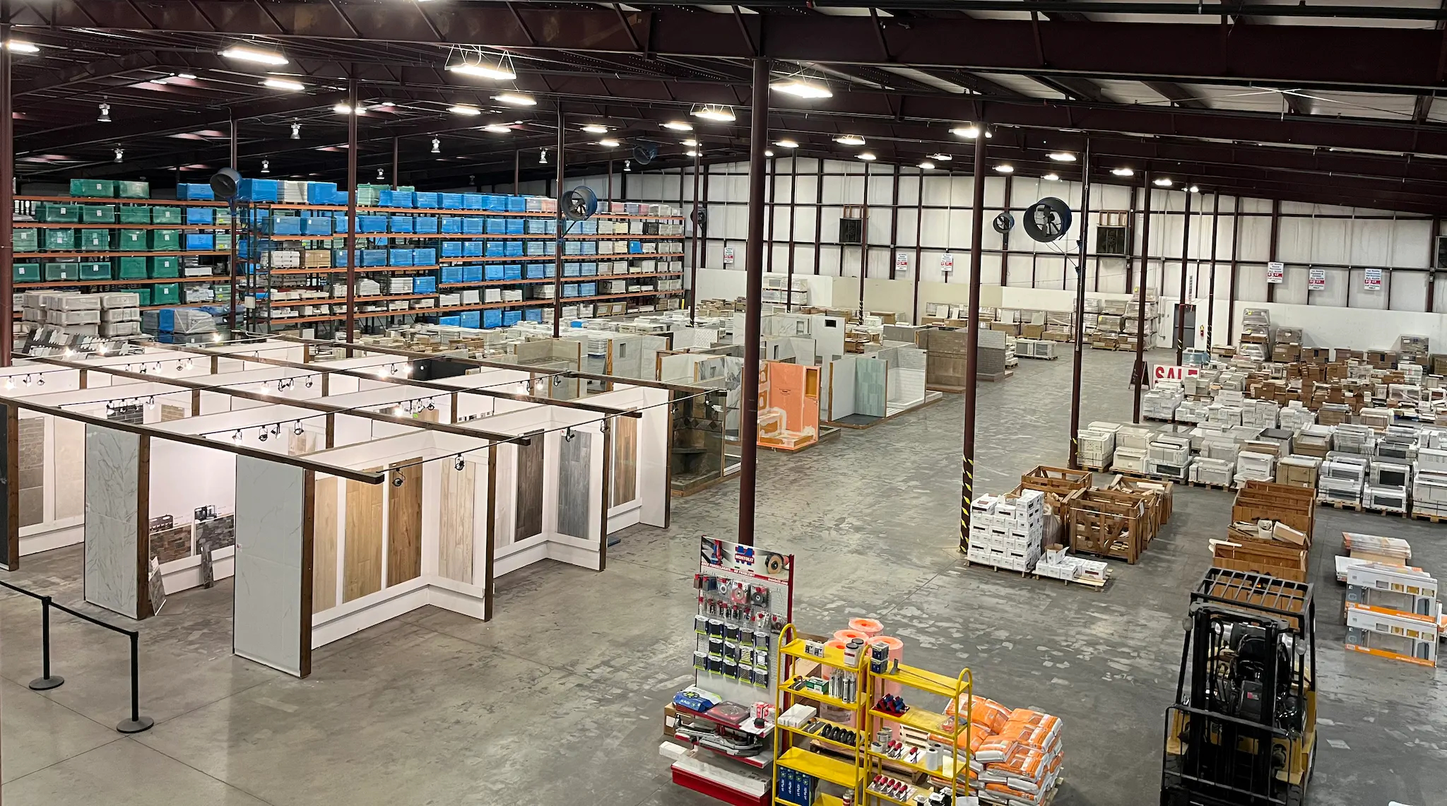Tile Factory Direct showroom interior with extensive tile inventory and hands-on design displays.