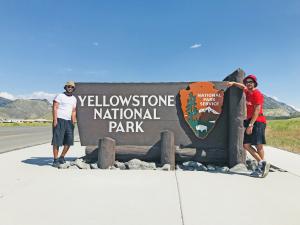 Two Summer Work Travel participants pose at the entrance of Yellowstone National Park