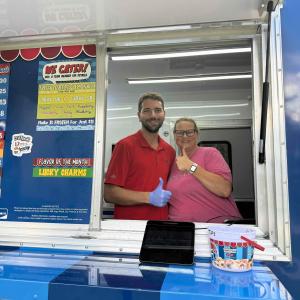 DonutNV franchise owners standing in the window of their mobile donut truck