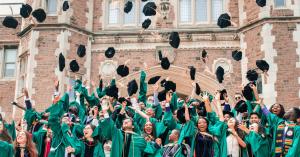 Graduating College Students WashU ecstatic and happy throwing the hat in the air
