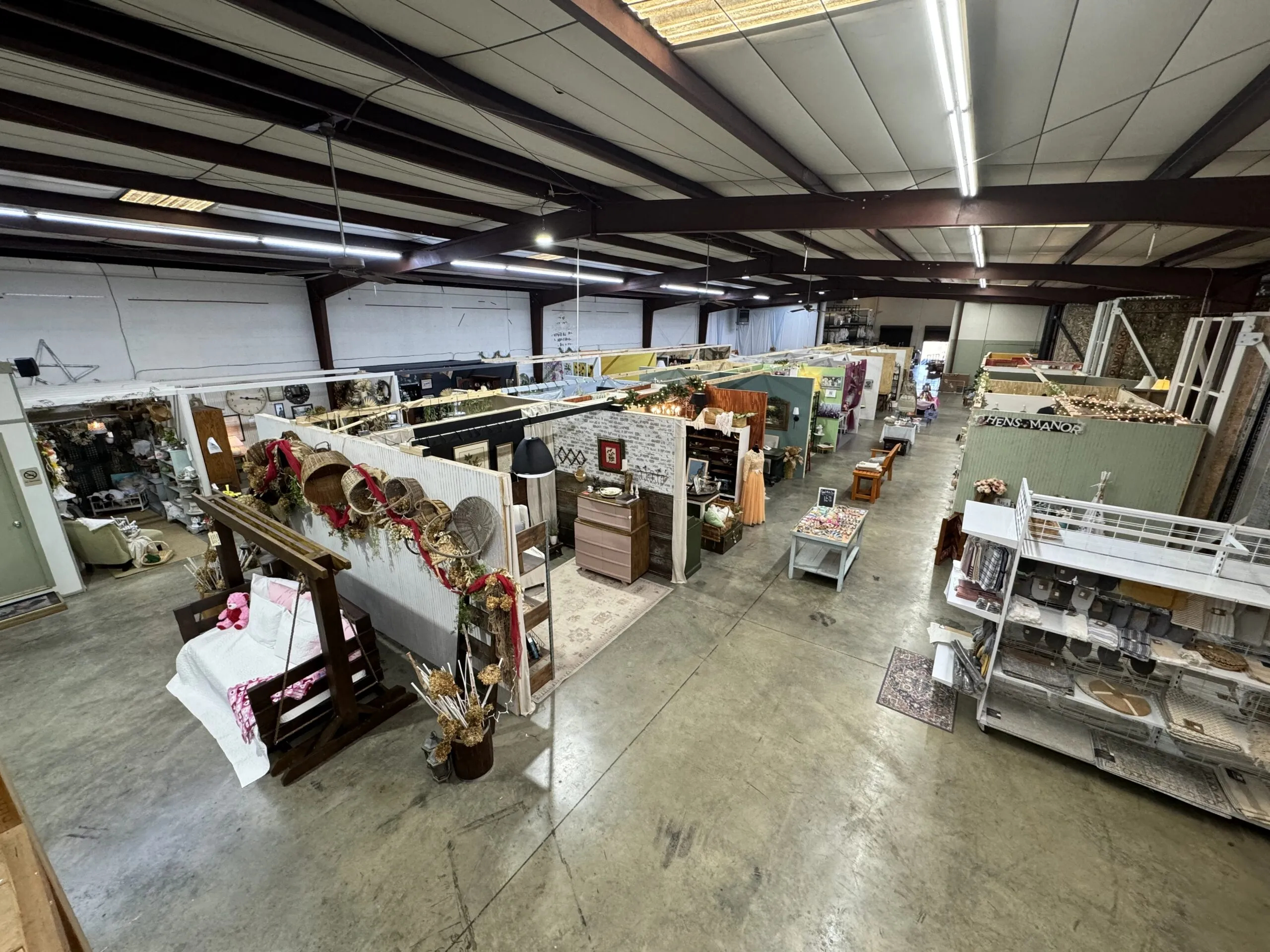 Showroom interior with vendor booths and antique displays.