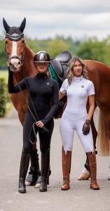 Royal Equestrian Cleopatra Riding Jumpsuit in black and white from the Regalia Di Roma Collection, featuring compression fit and couture tailoring for equestrian inspired activewear.