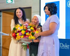 Dr. Zanele Mbeki, founder of the Women’s Development Bank and women’s rights activist, receives colourful flowers from Pumla Molope, AWCA President and Dr. Sharmla Chetty, CEO of Duke Corporate Education, in recognition of her life-long contribution to up