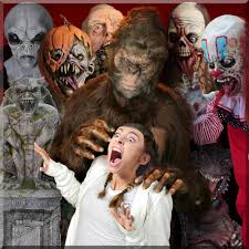 Bigfoot costume from The Horror Dome’s 2025 Professional Halloween Costume Collection grabs a screaming guest while surrounded by aliens, pumpkin creatures, zombies, and clowns. The image showcases the lifelike detail and theatrical impact of the brand’s
