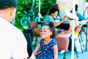 A little Black girl getting MassQed at the Arnold Arboretum at the MAssQ Ball 2022