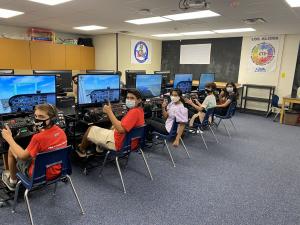Students giving a thumbs up while sitting on STEMPILOT's best selling unit the Edustation