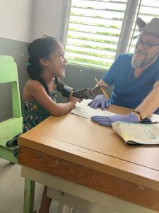 Young Girl Practices writing with new prosthetic limb