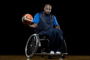 Derrick Stewart-Poole Posing with Basketball on New Mobility Photo Shoot