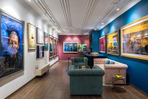 Interior of Réhahn’s fine art photography gallery in Vietnam, with cozy lounge seating and walls filled with colorful, framed photographs.