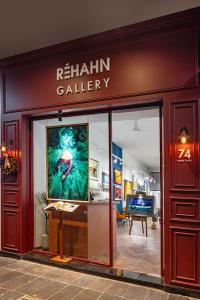 Front entrance of Réhahn Gallery at 74 Dong Khoi, Ho Chi Minh City, featuring a large portrait photograph and framed artworks inside.